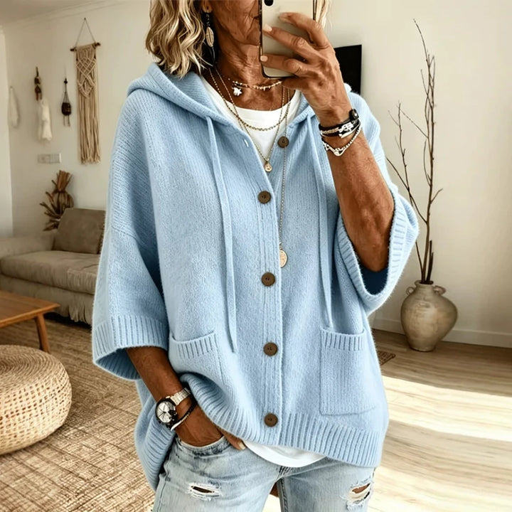 Woman wearing light blue hooded button-front cardigan