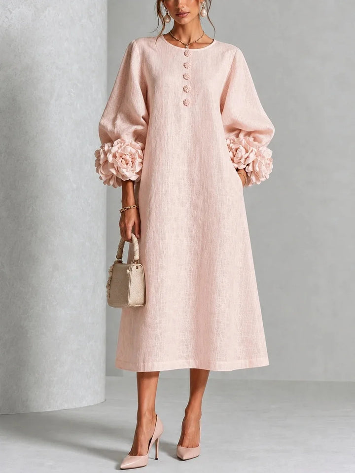 Woman wearing pink midi dress with 3D floral lantern sleeve cuffs