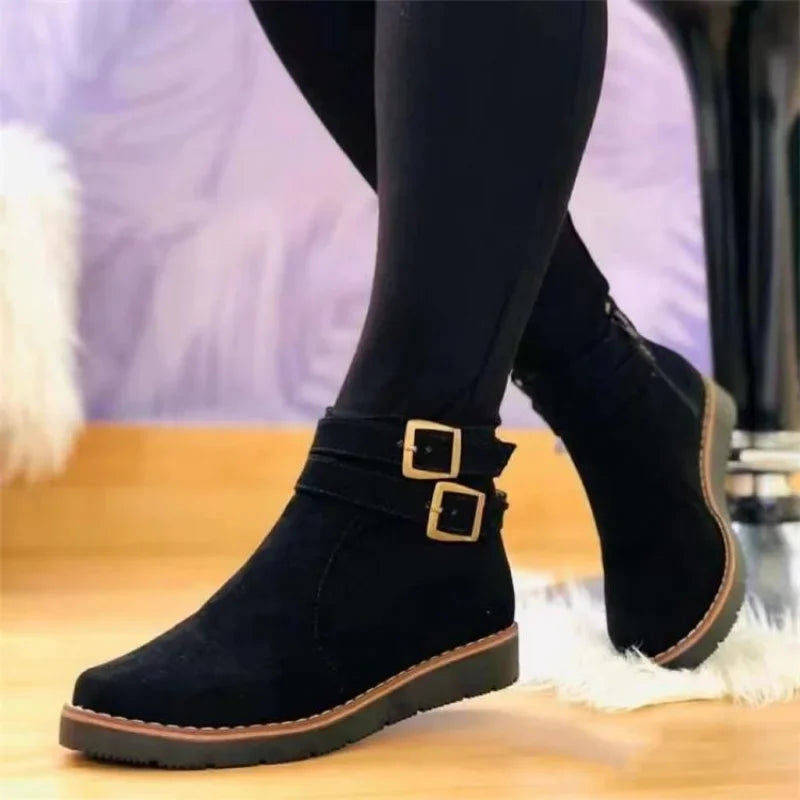 Black suede ankle boot with double buckle straps, side view