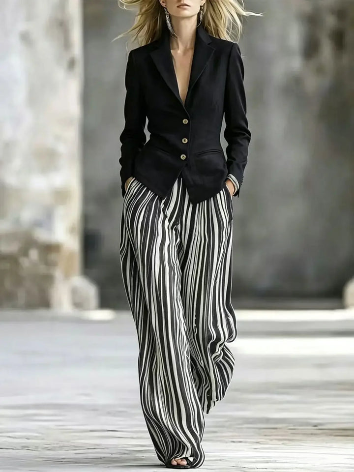 Woman wearing black blazer with striped wide leg pants suit