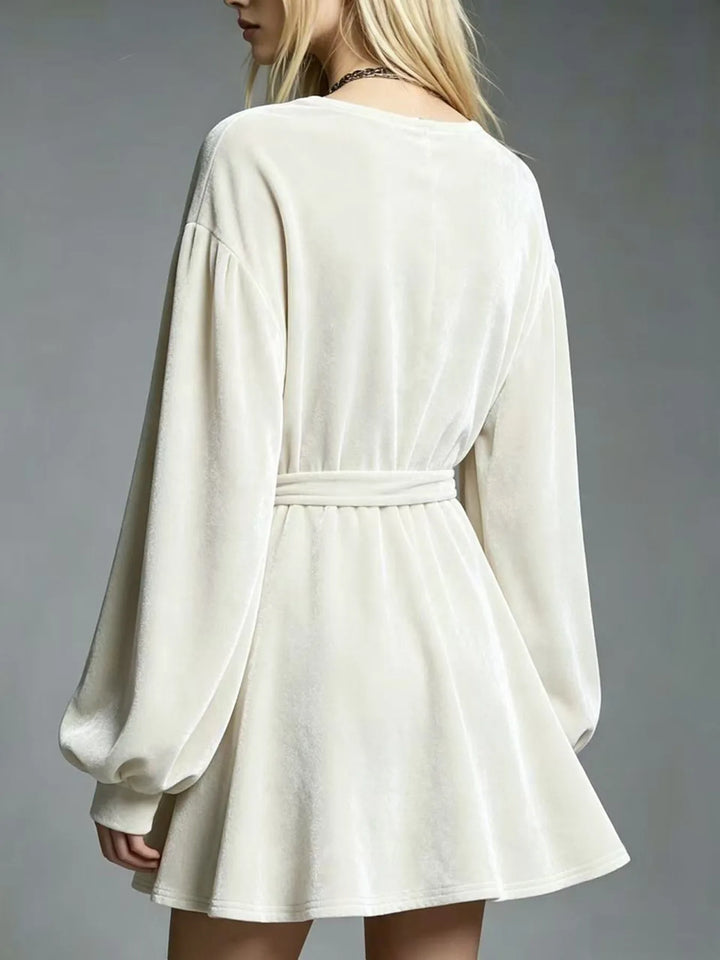 Ivory velvet mini dress back view showing tie belt and A-line skirt