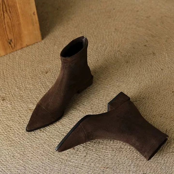 Pair of brown suede ankle boots on floor