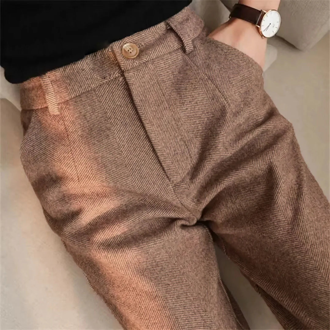 Close up of herringbone wool-blend trousers in tan on model
