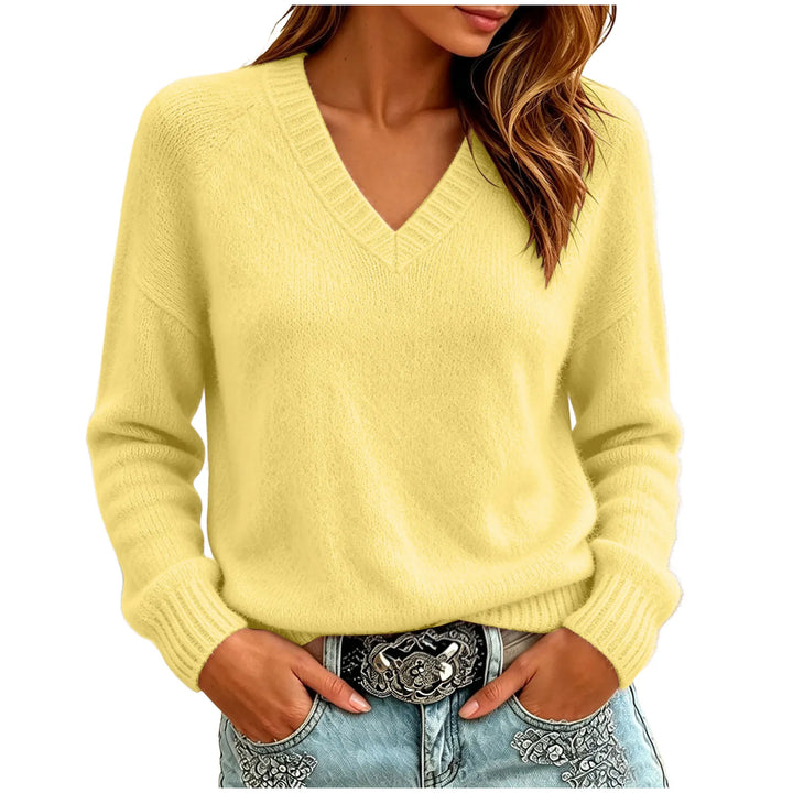 Woman wearing yellow oversized V-neck knit sweater with hands in pockets