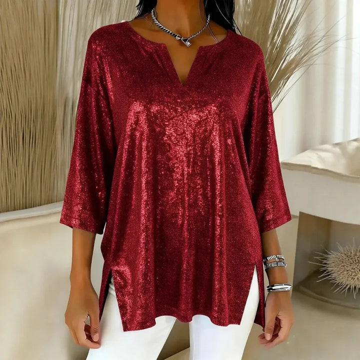 Woman wearing red shimmer oversized blouse with V-neck