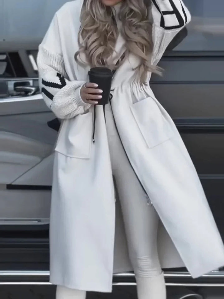 Close up of white hooded maxi coat with drawstring waist and patch pocket