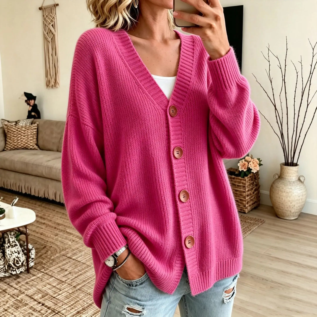 Woman wearing pink oversized button-front V-neck cardigan
