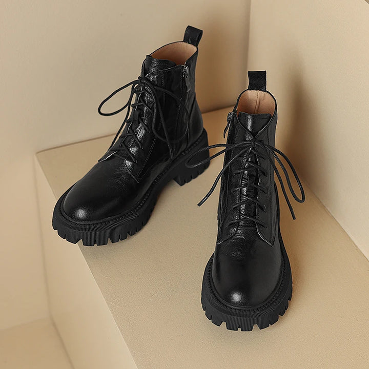 Pair of black lace-up ankle boots on display step