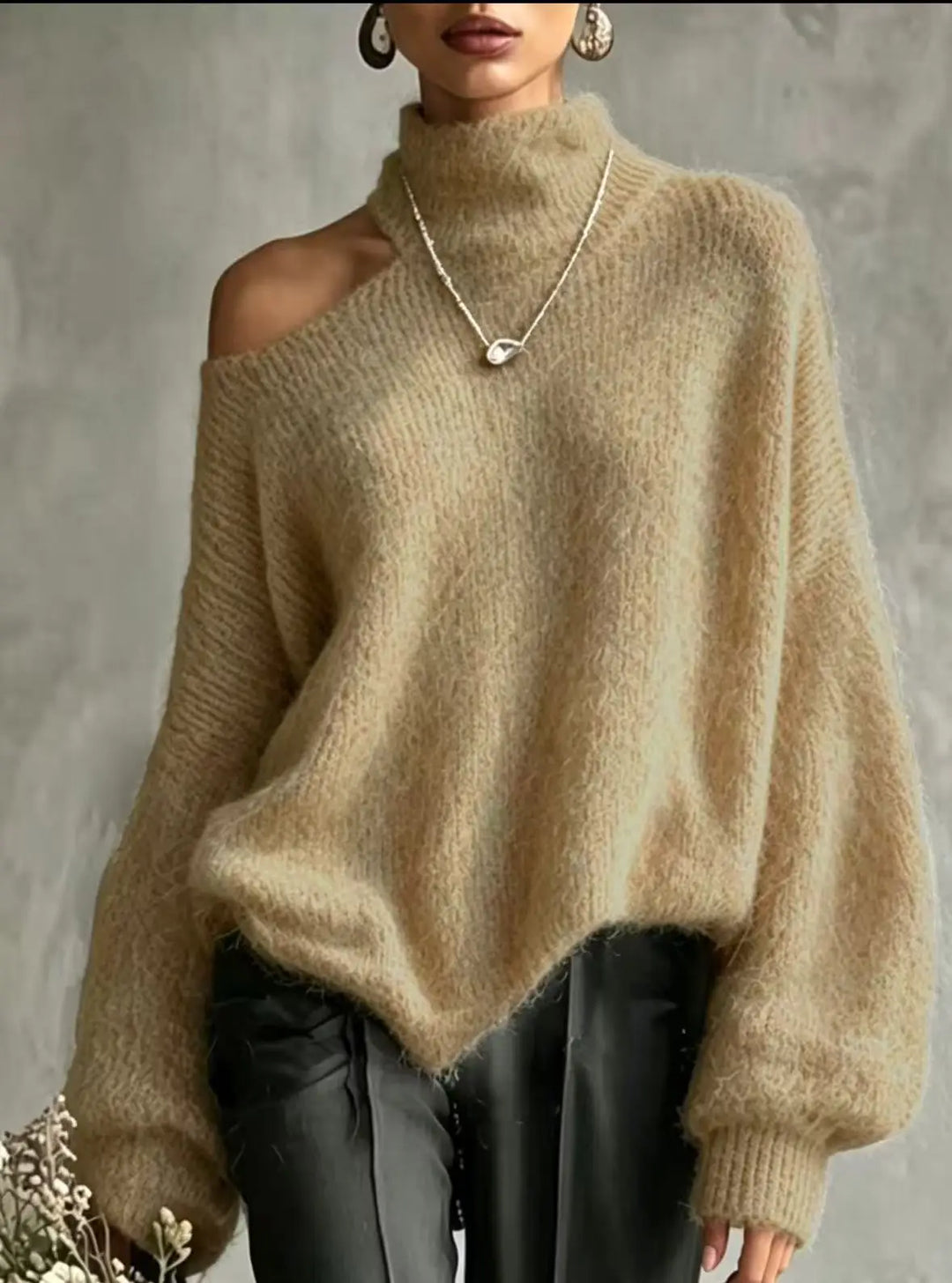 Woman wearing camel colored cutout shoulder turtleneck sweater