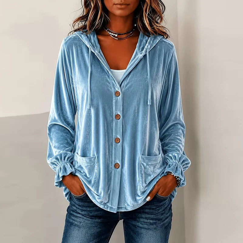 Woman wearing light blue hooded velvet jacket with buttons