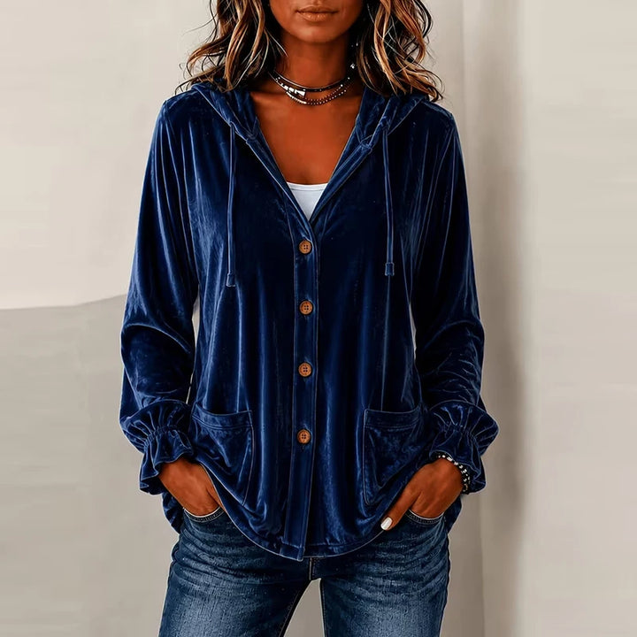 Woman wearing navy blue hooded velvet jacket with buttons