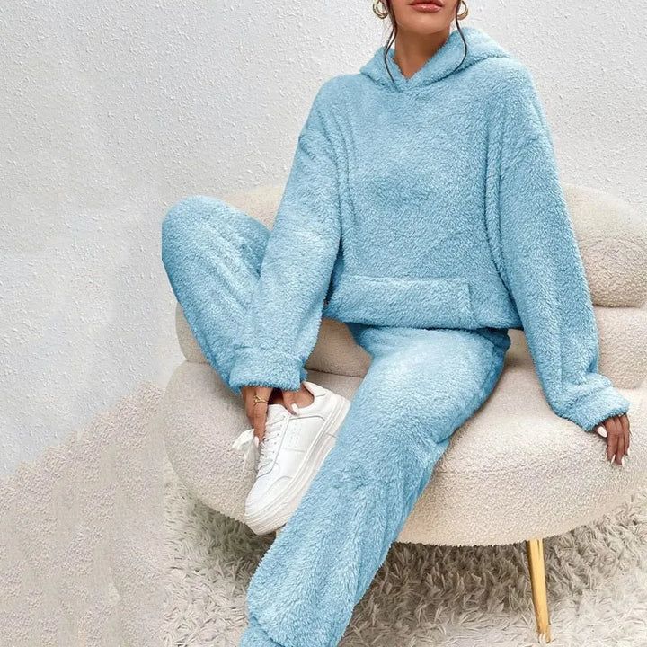 Woman wearing light blue brushed fleece hooded loungewear set on chair