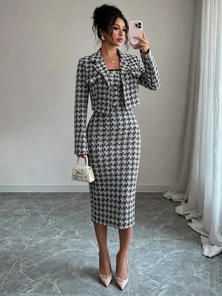 Woman in black and white houndstooth cropped jacket and sheath dress set