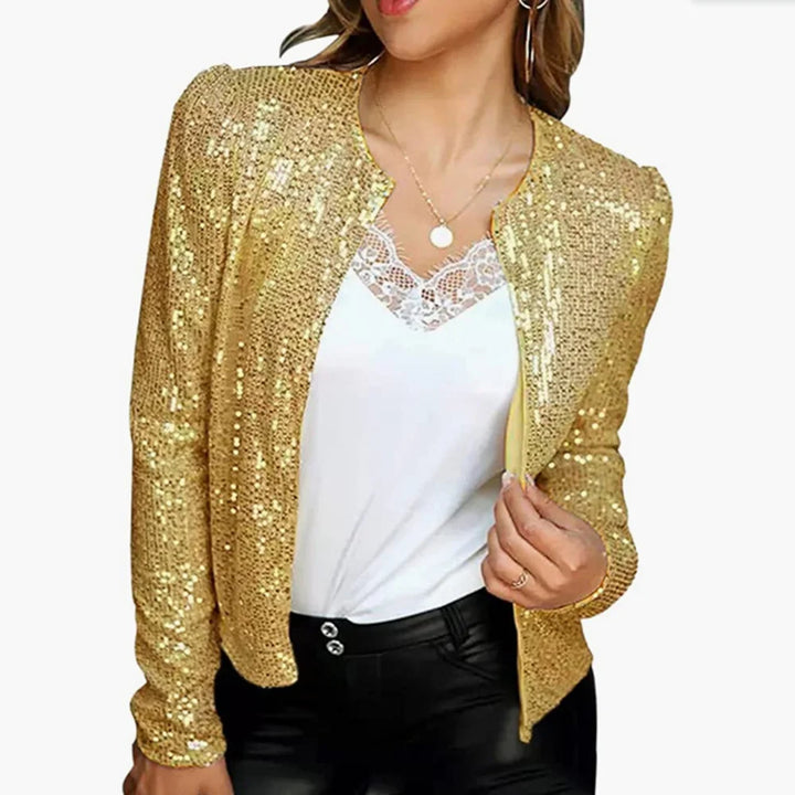 Woman wearing gold sequin jacket over lace cami