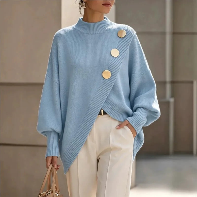 Woman wearing light blue asymmetric hem sweater with gold buttons