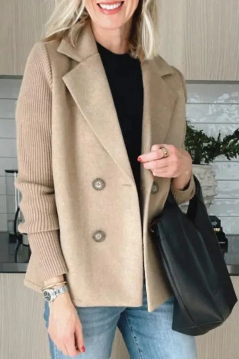 Woman wearing camel double-breasted blazer with ribbed knit sleeves smiling