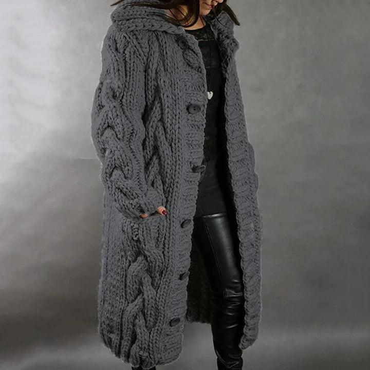 Woman wearing dark grey hooded cable knit long cardigan, side view