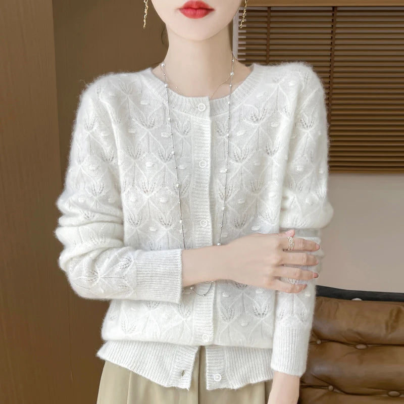 Woman wearing white jacquard knit cardigan with button front, front view