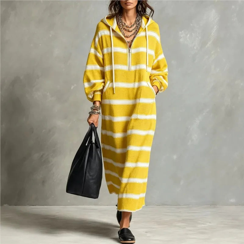 Woman walking in yellow and white striped half-zip hoodie maxi dress