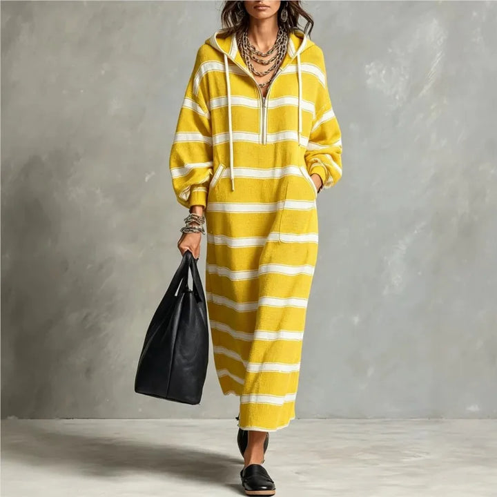 Woman walking in yellow and white striped half-zip hoodie maxi dress