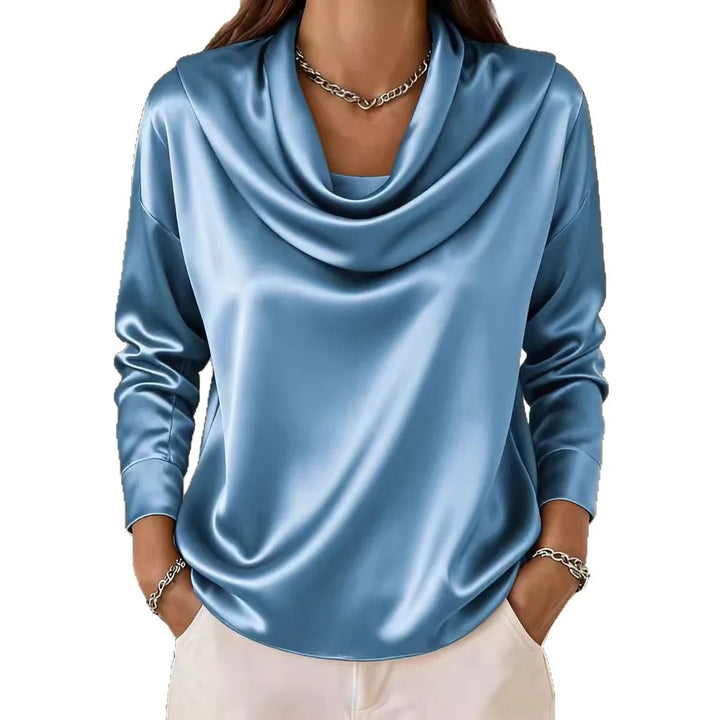 Woman wearing blue satin cowl neck blouse on white background