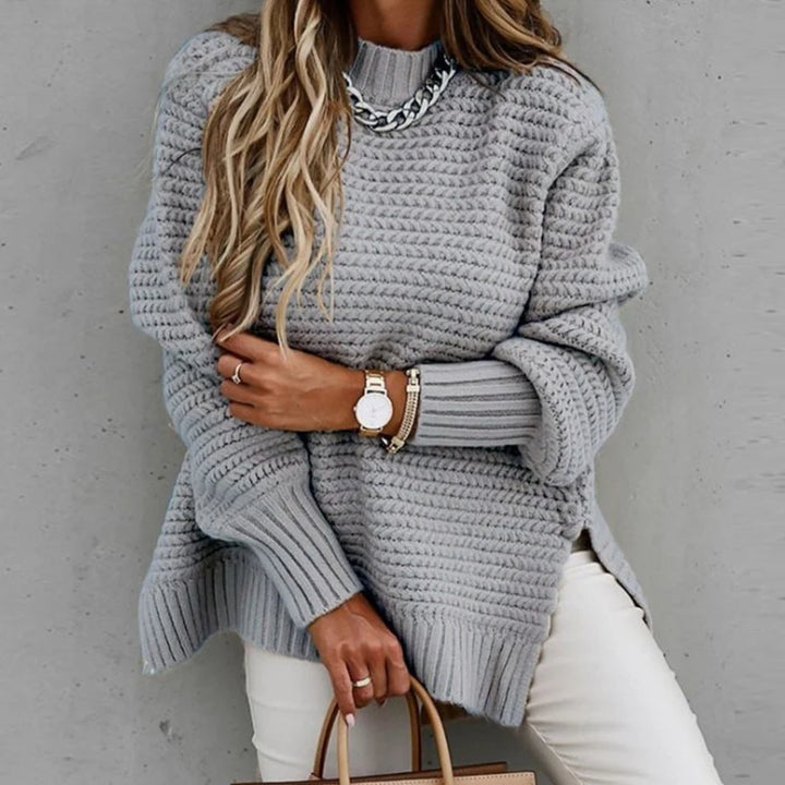 Woman wearing grey chunky knit oversized sweater with mock neck