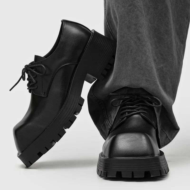 Black leather derby shoes with chunky lug sole shown crossed