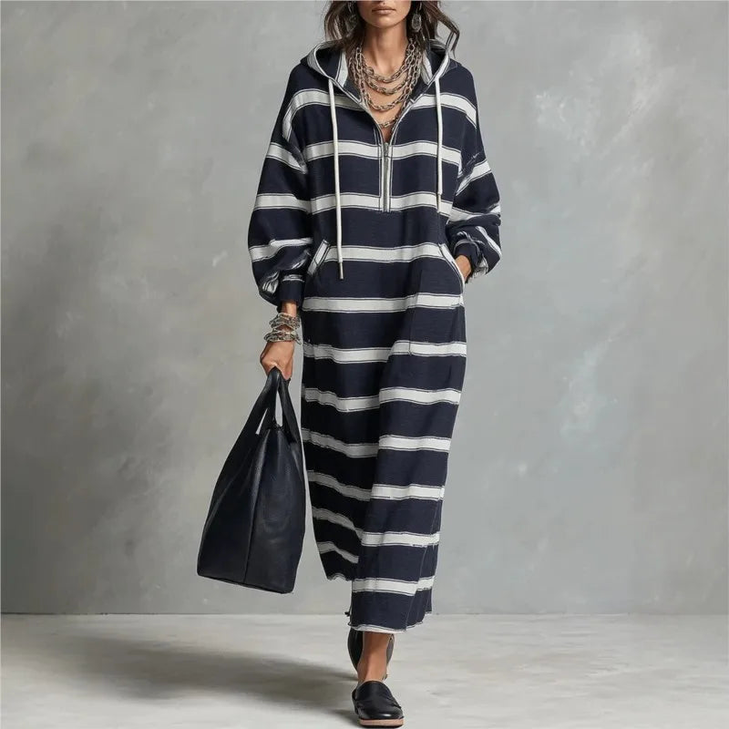 Woman walking in navy and white striped half-zip hoodie maxi dress