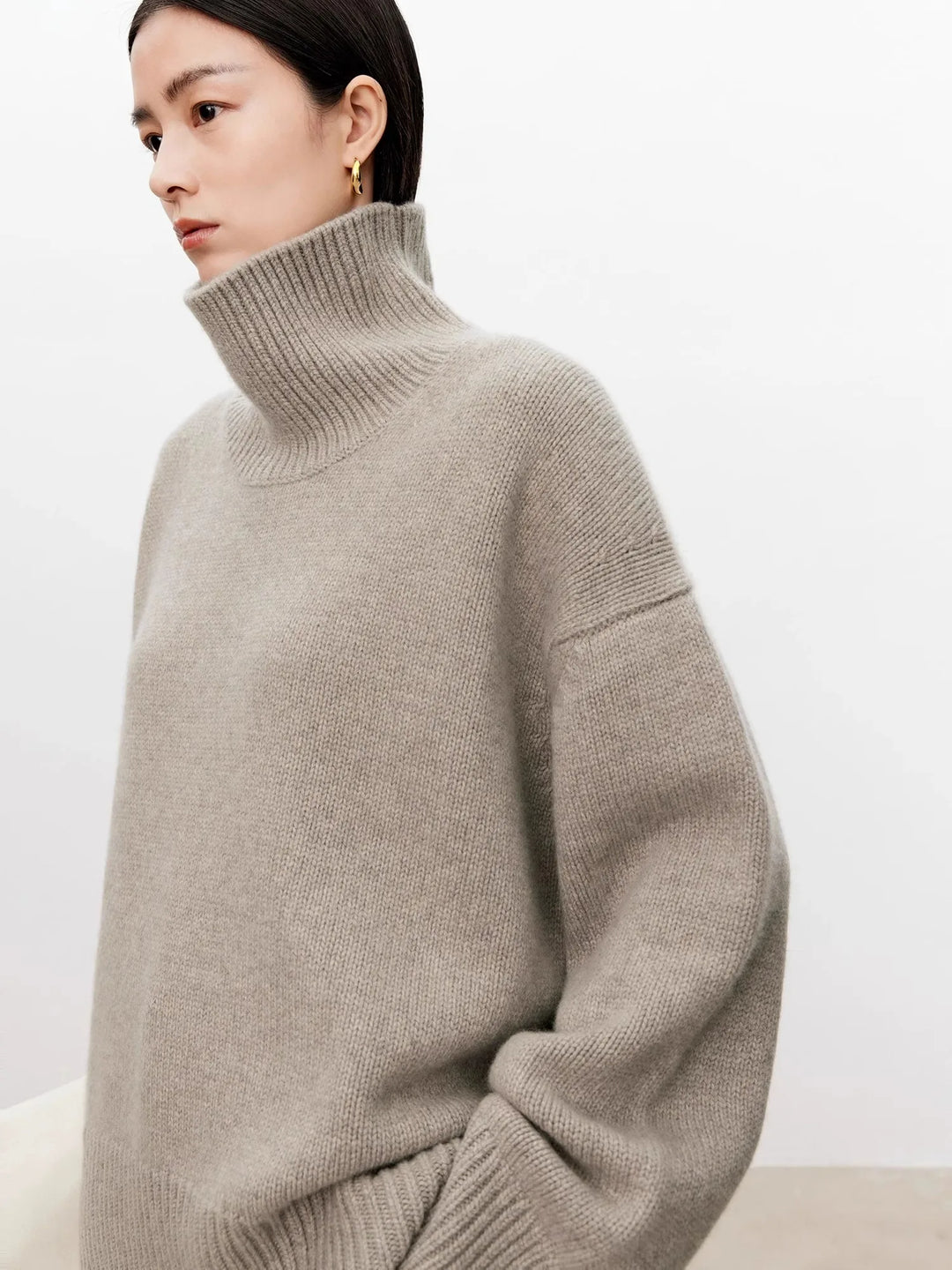 Close-up of ribbed turtleneck collar on taupe cashmere sweater