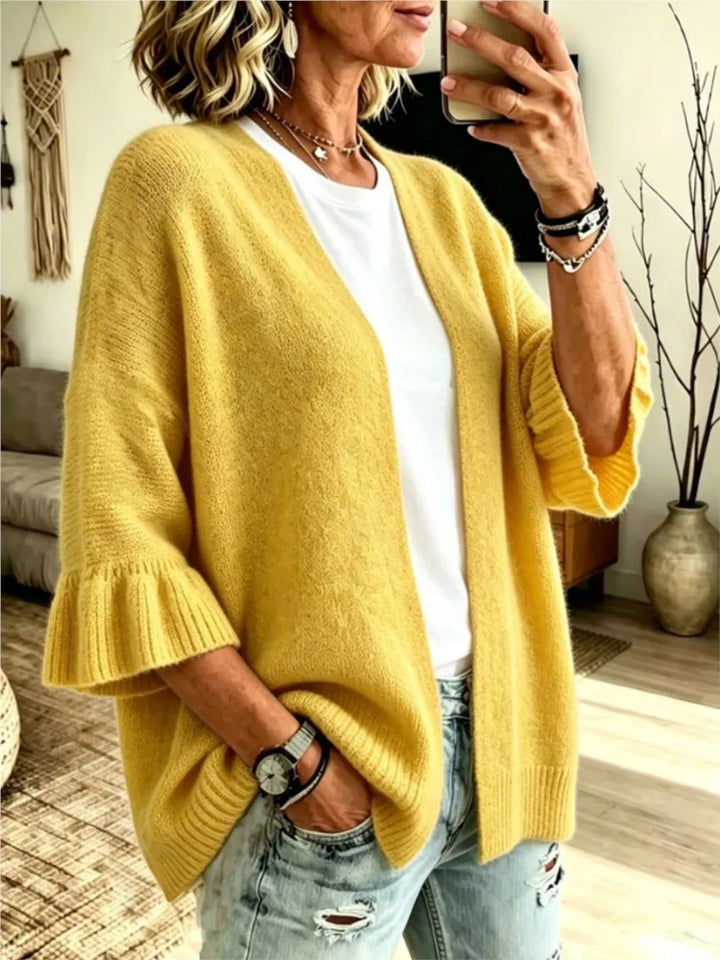 Yellow knit cardigan with ruffle cuffs, front view