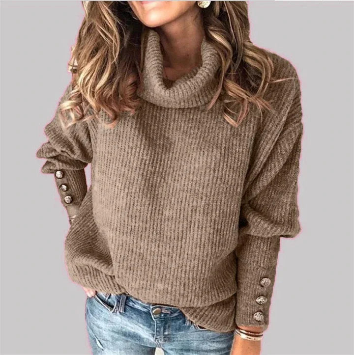 Woman wearing khaki ribbed turtleneck sweater with button cuffs