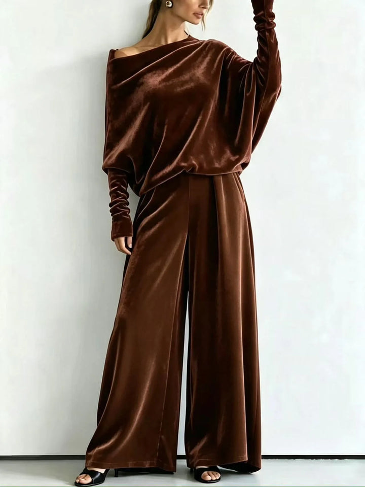 Woman wearing dark brown velvet off-shoulder top and wide leg pants set