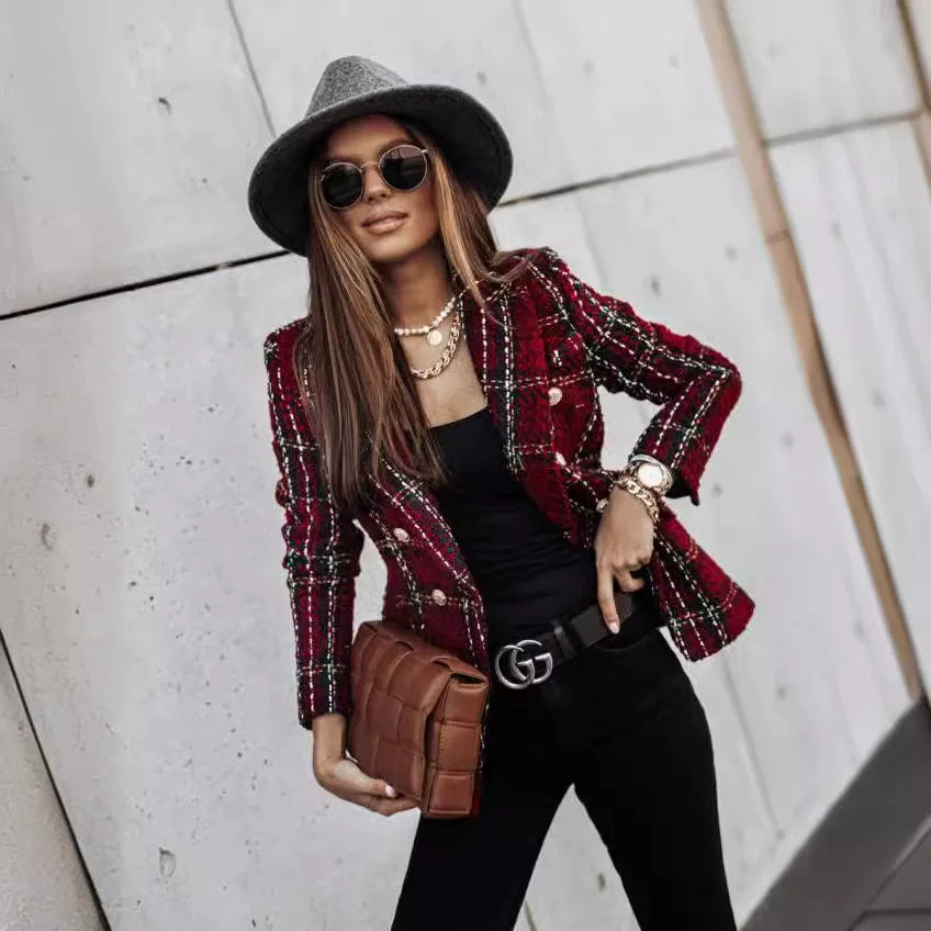 Woman wearing burgundy plaid double-breasted blazer with black top