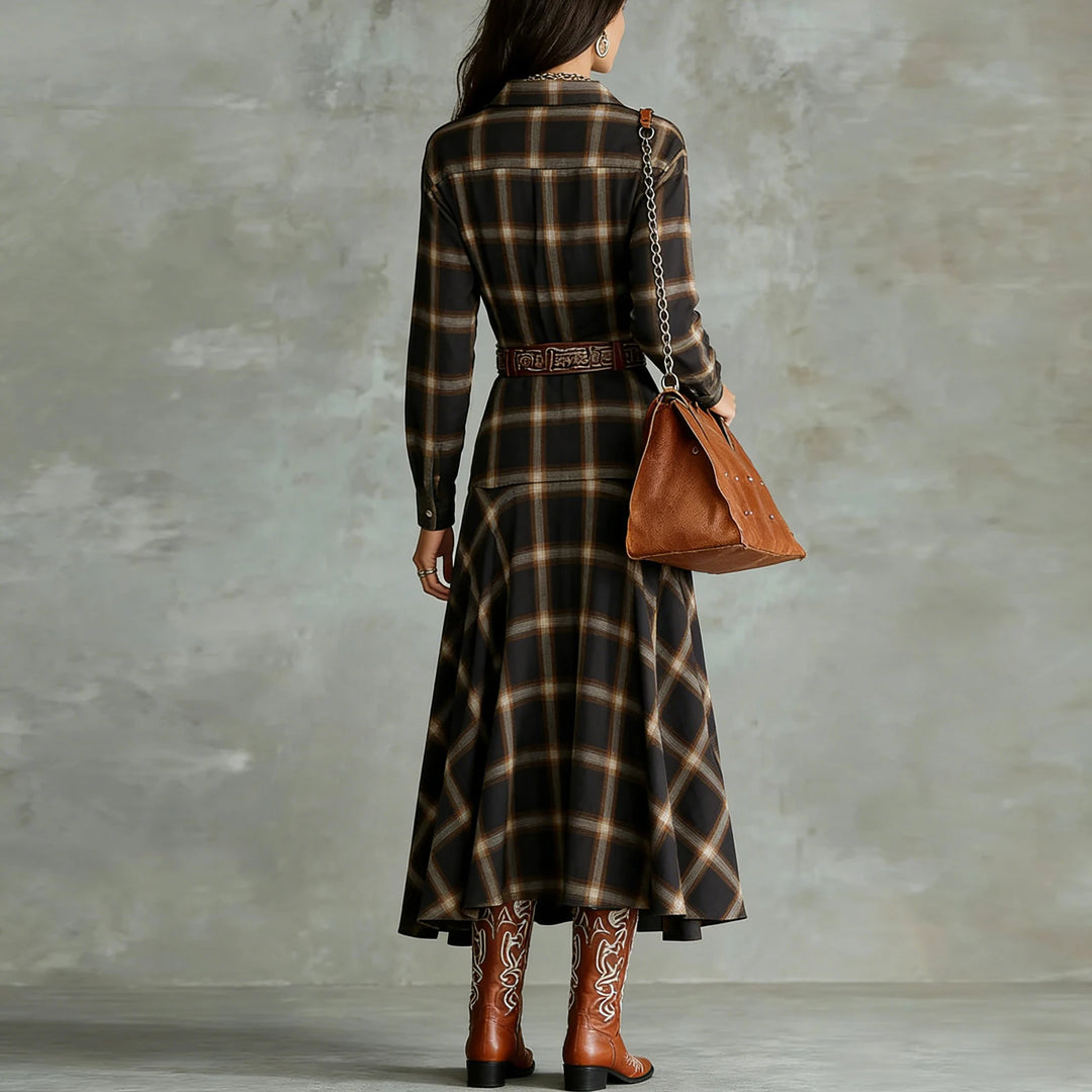 Back view of black plaid shirt dress with belt and flowing skirt