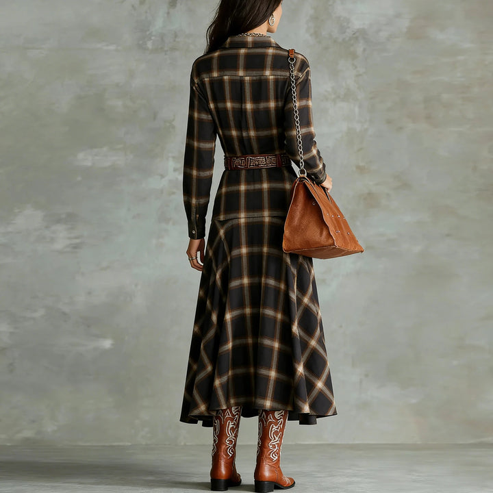 Back view of black plaid shirt dress with belt and flowing skirt