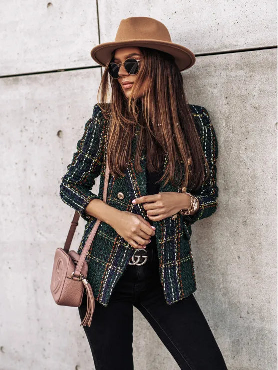 Woman wearing green plaid blazer over black top with accessories