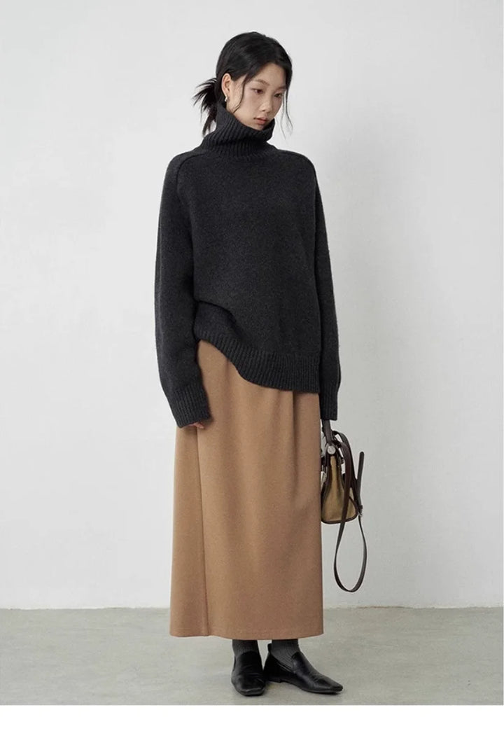 Woman wearing black turtleneck sweater with camel skirt