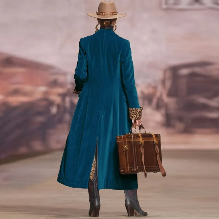 Woman in blue velvet long trench coat, back view