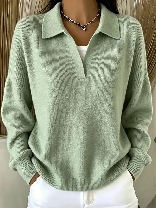 Woman wearing light green ribbed knit polo sweater with deep V neckline
