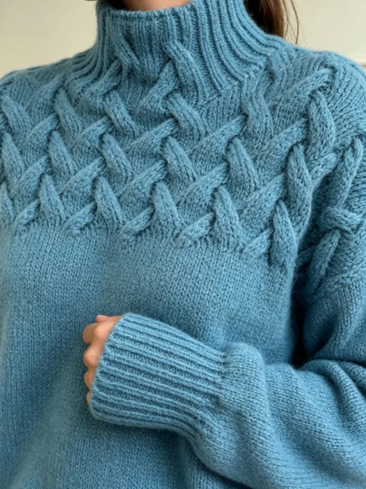 Close up of cable knit yoke and turtleneck collar in sky blue