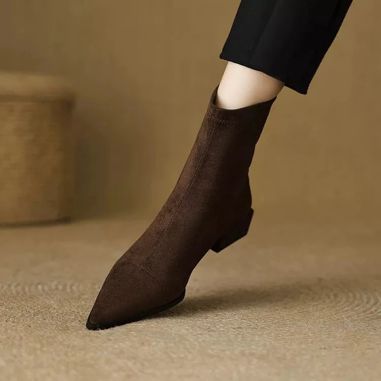 Brown suede ankle boot detail on foot with pointed toe