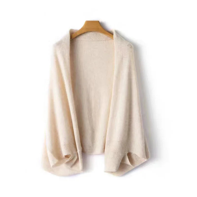 Cream knit wrap shawl draped on hanger