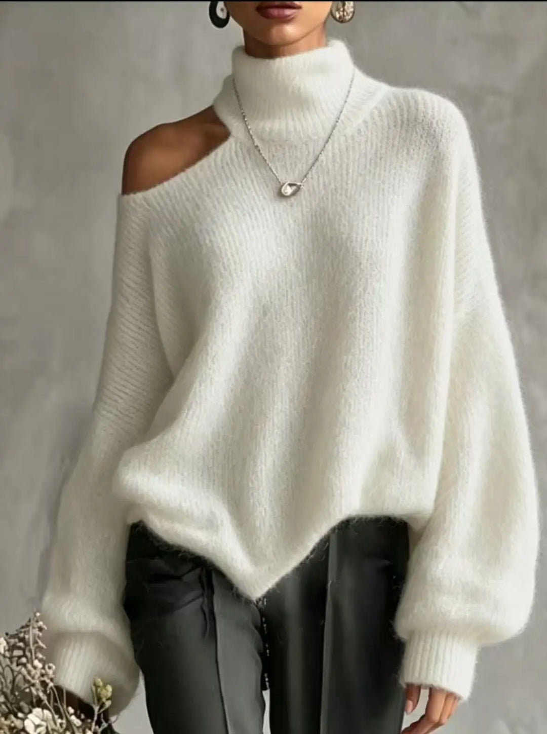 Woman wearing white cutout shoulder turtleneck sweater