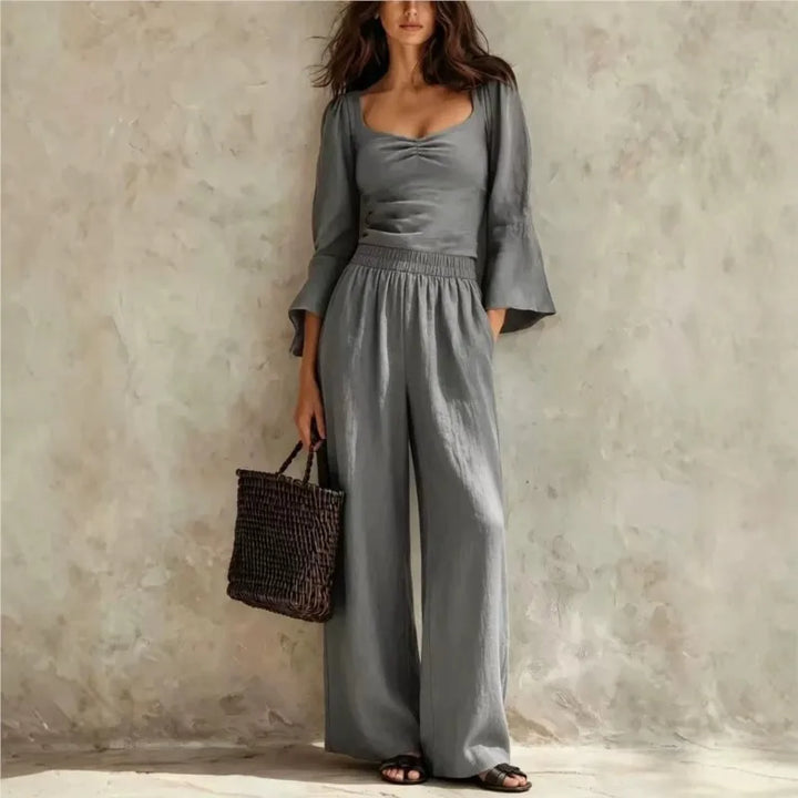 Woman wearing gray ruched bodice top and wide leg pants set