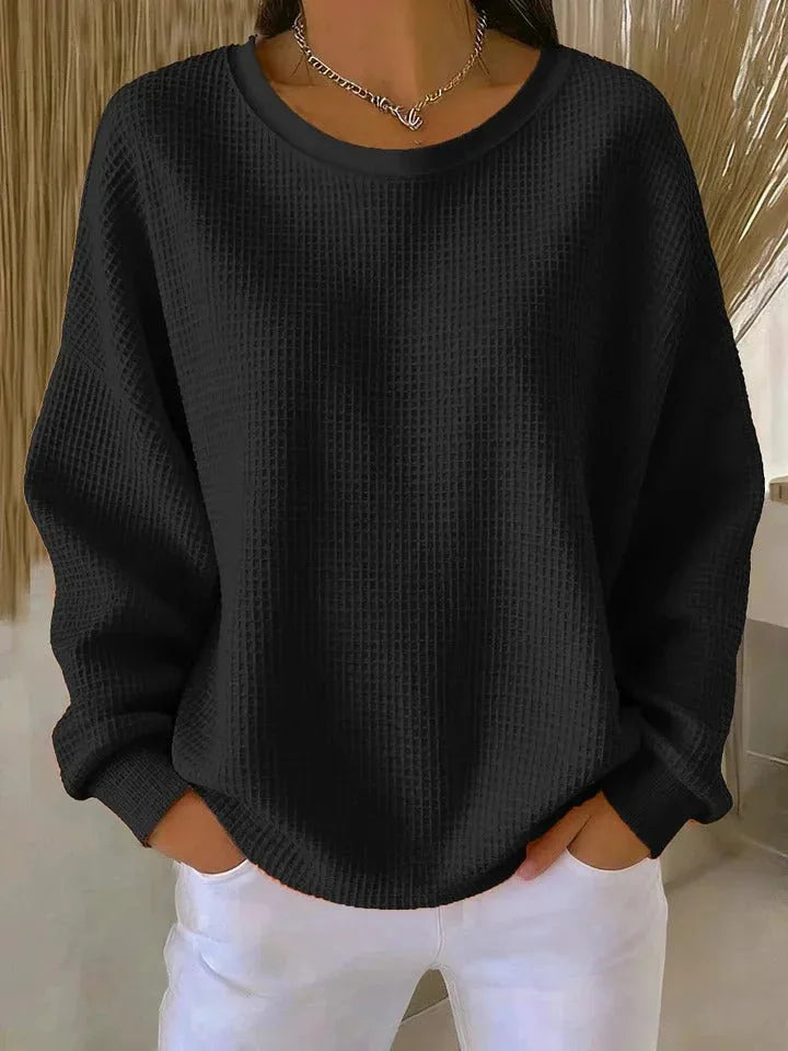 Woman wearing black waffle knit oversized top