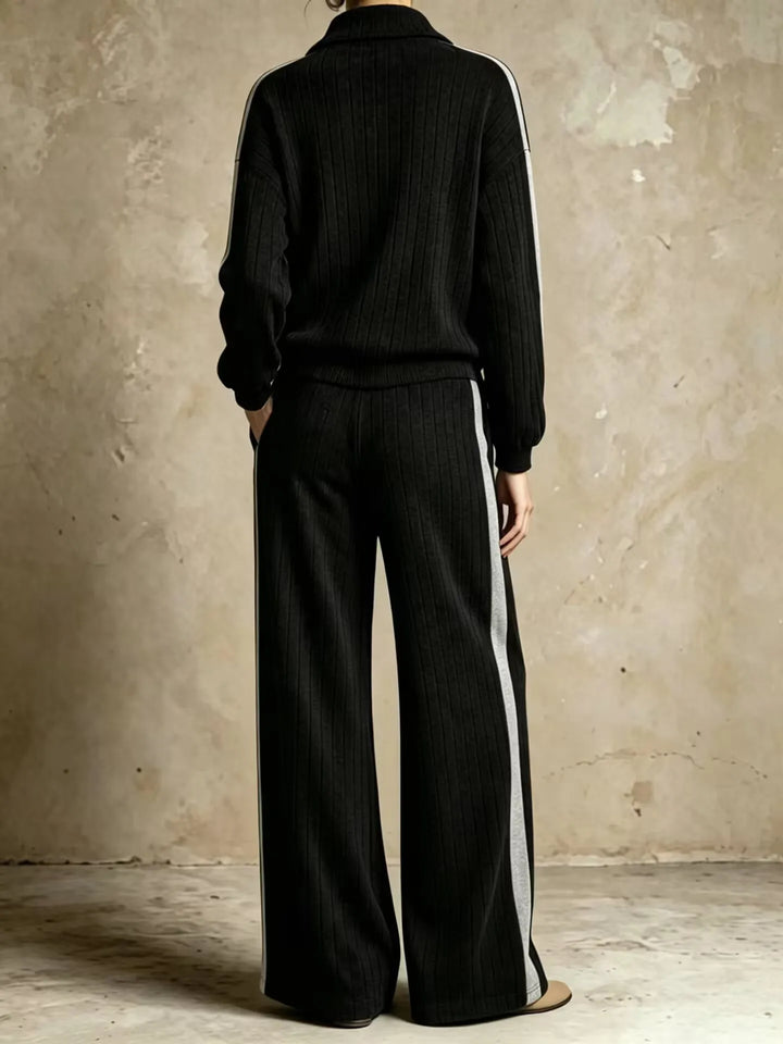 Back view of black ribbed knit two piece set with gray side stripe
