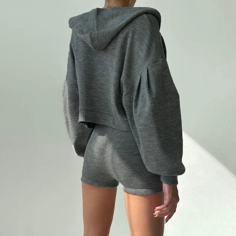 Back view of woman wearing gray ribbed knit hoodie and shorts set