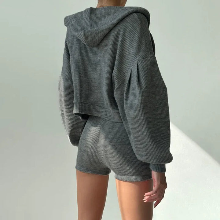 Back view of woman wearing gray ribbed knit hoodie and shorts set