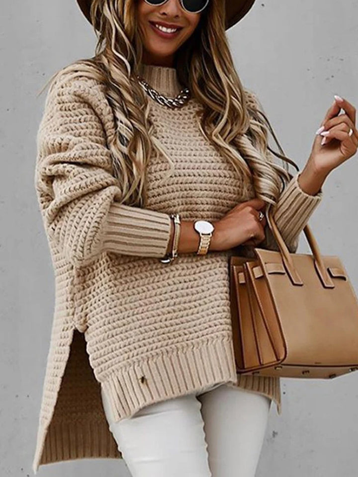 Woman wearing khaki chunky knit sweater with side slit detail