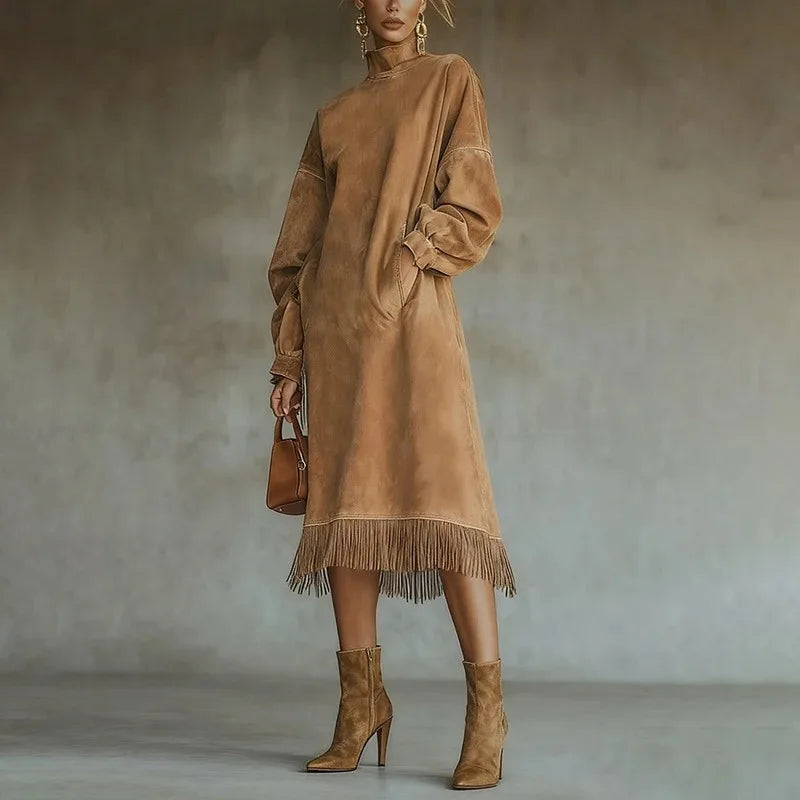 Woman wearing brown mock neck sweatshirt dress with tassel fringe hem, front view